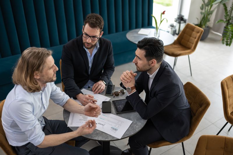 Businesspeople discussing reinsurance options