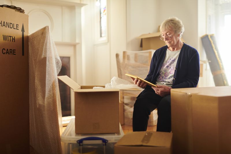 Senior woman packing up her house before moving.