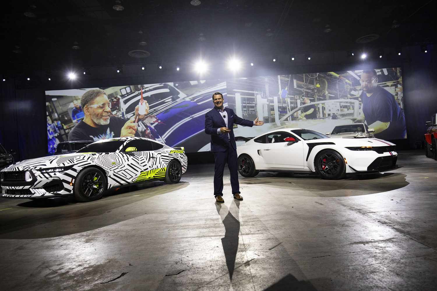 Ford Motor Company President and CEO Jim Farley stands between the Ford Mustang RTR (left) and the Ford Mustang GTD (right) at a Ford "Detroit Proud" event at the 2025 Detroit Auto Show at Huntington Place on January 9, 2025