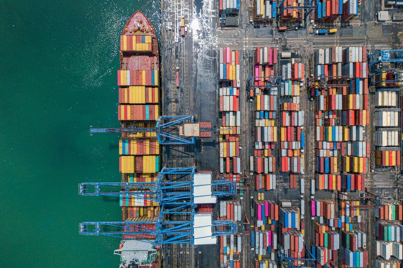 aerial view of shipping containers at port with a ship