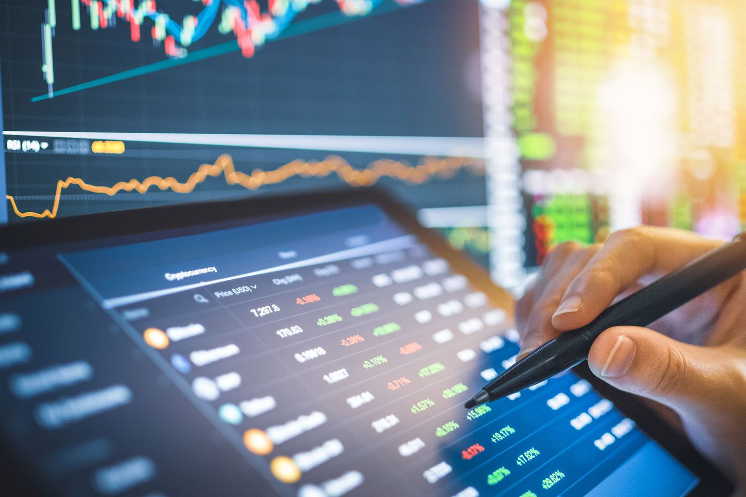 Hand of person tracking cryptocurrency prices on a handheld screen.