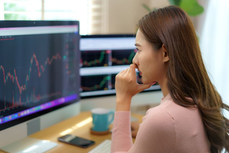 Woman nervously looking at her stock performance.