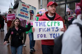 Activists participate in a rally outside the Consumer Financial Protection Bureau (CFPB) on March 24, 2025 in Washington, DC. Activists held a rally to support federal workers affected by DOGE cuts.