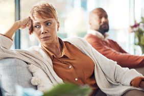 Mature couple, divorce and fighting on sofa in house, home living room or marriage counseling therapy. 