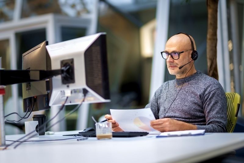 Person working on computers at a desk
