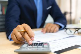 Hands of bank officer calculating loans