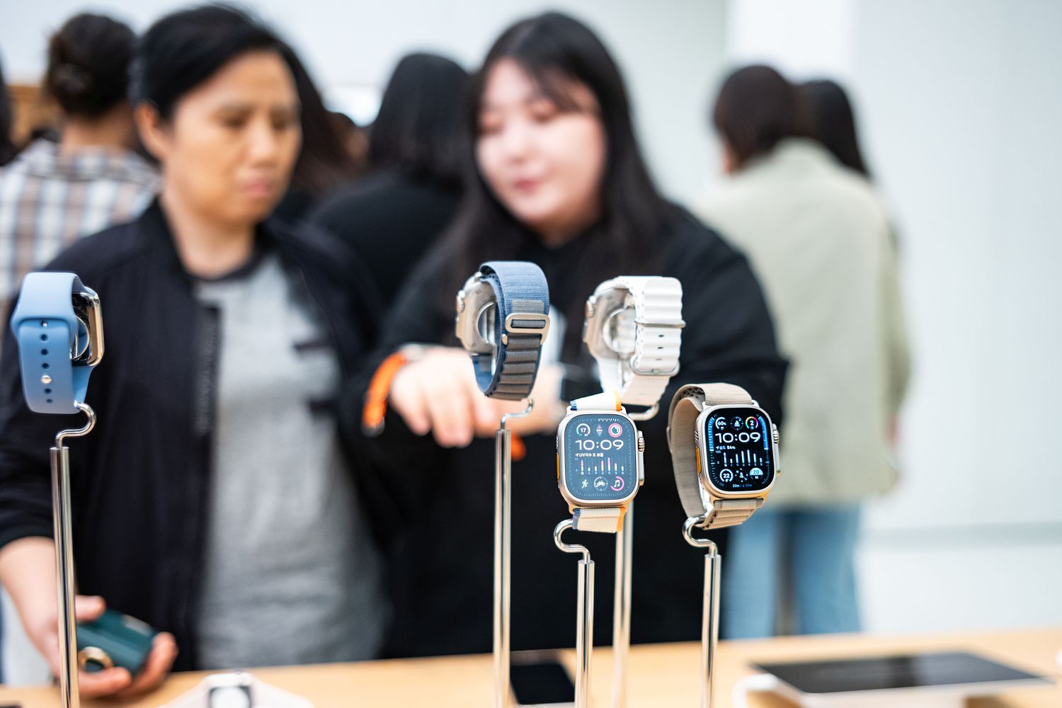 Customers looking at newly launched Apple watches in October 2023 in Seoul