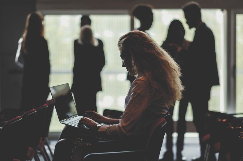 Businesswoman using laptop in conference room