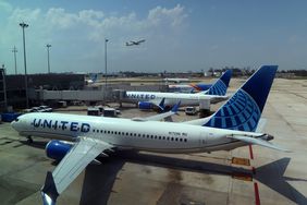 A United Airlines airplane arrives at a gate.