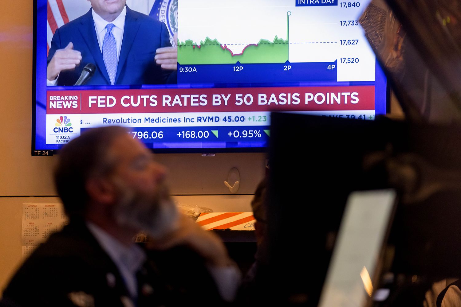 A television station broadcasts the Federal Reserve's interest-rate cut on the floor of the New York Stock Exchange.