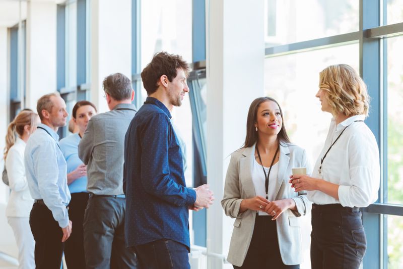 Group of finanial advisors at a conference during a coffee break.