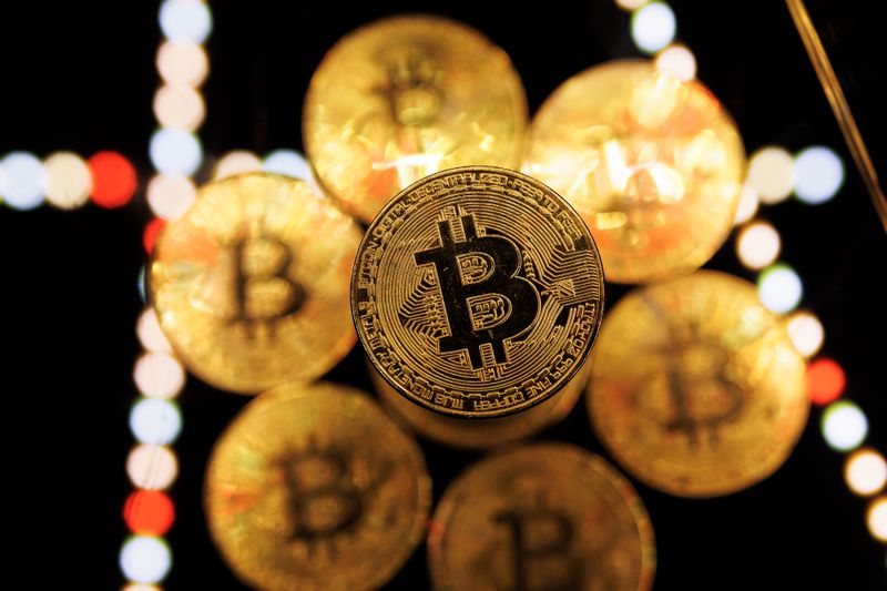 An illustration of golden physical bitcoins on a multicolored background. 