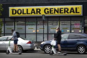 People and cars are seen in front of a Dollar General store in Chicago.