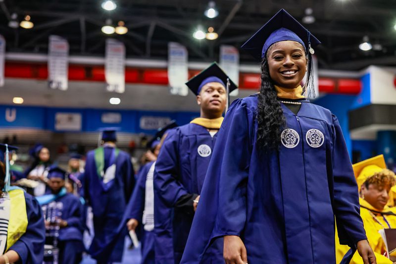 A Jackson State University graduate smiles moments before stepping onto the stage to receive her degree.