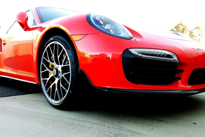 Red luxury sports car in a parking lot