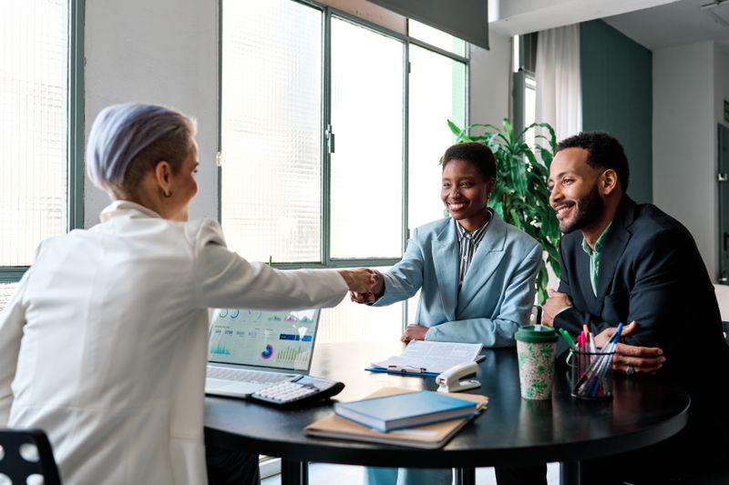 Businesswoman closing a deal with clients.