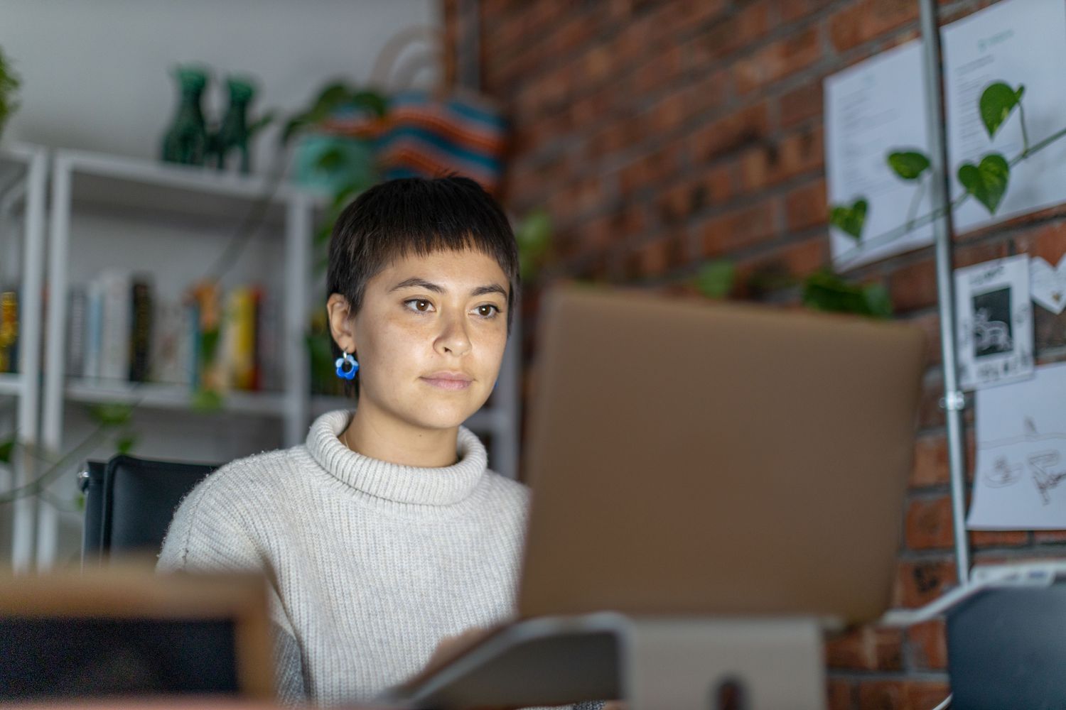 Person using a laptop computer at a home desk