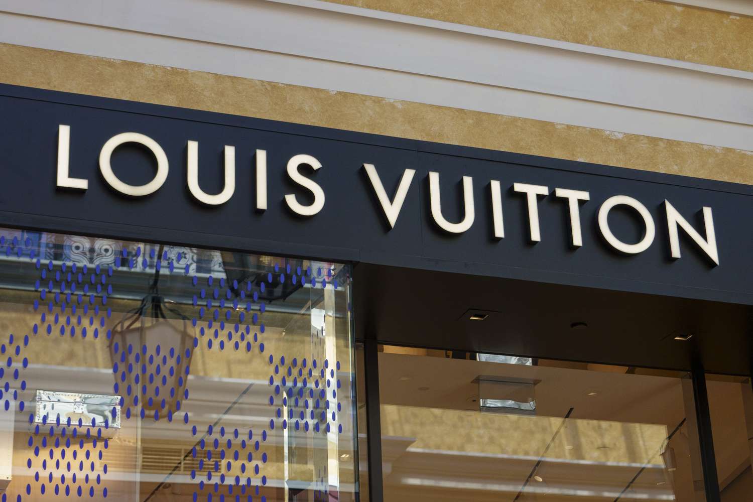 The Louis Vuitton logo above the entrance to a store