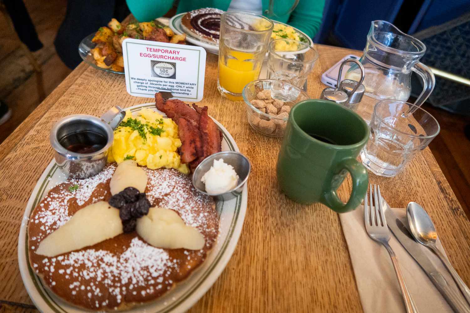 The French restaurant "La Note," gives notice and charges a "temporary egg/surcharge" of $.50 per egg, due to the high cost of eggs, in Berkeley, California, photographed March 15, 2025.