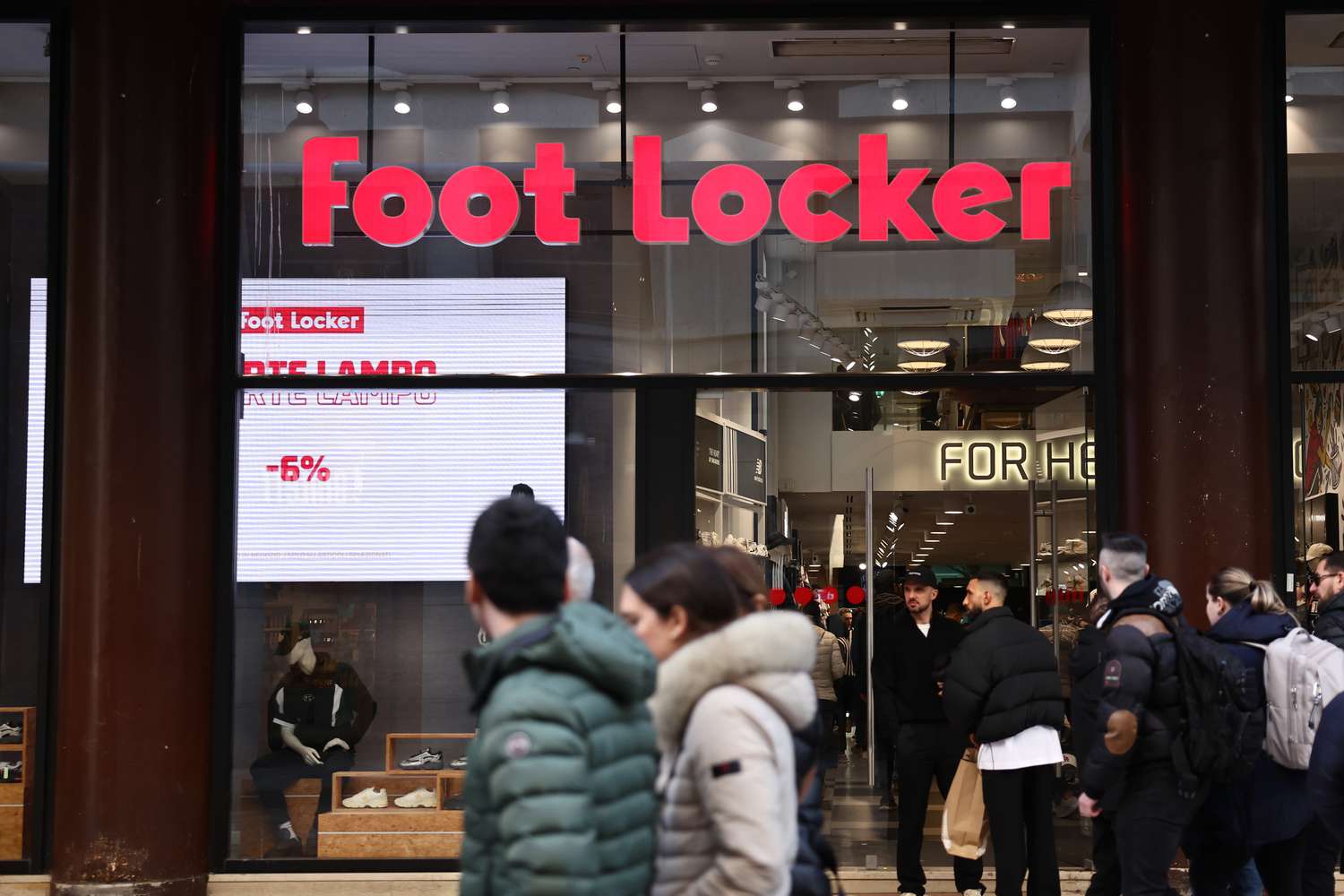 People walk past a Foot Locker store in Milan, Italy, in March. 