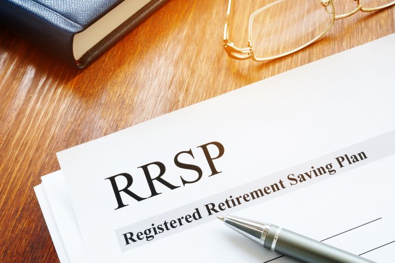 RRSP Registered Retirement Saving Plan documents on table.