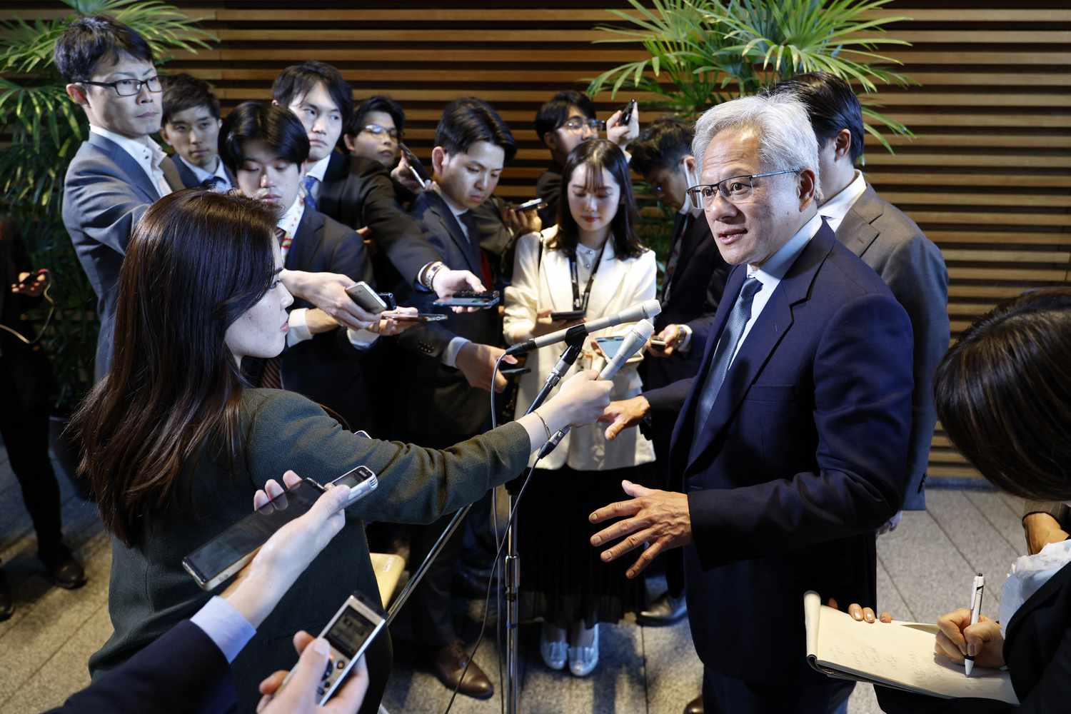 Nvidia CEO Jensen Huang (R) answers to questions from reporters after his meeting with Japanese Prime Minister Shigeru Ishiba at the prime minister's official residence in Tokyo on April 21, 2025. 