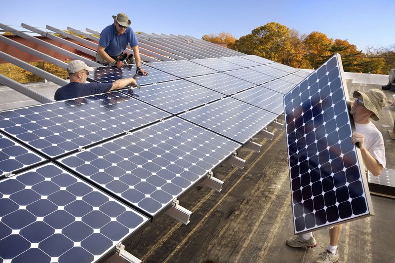 Men installing solar photovoltaic panels