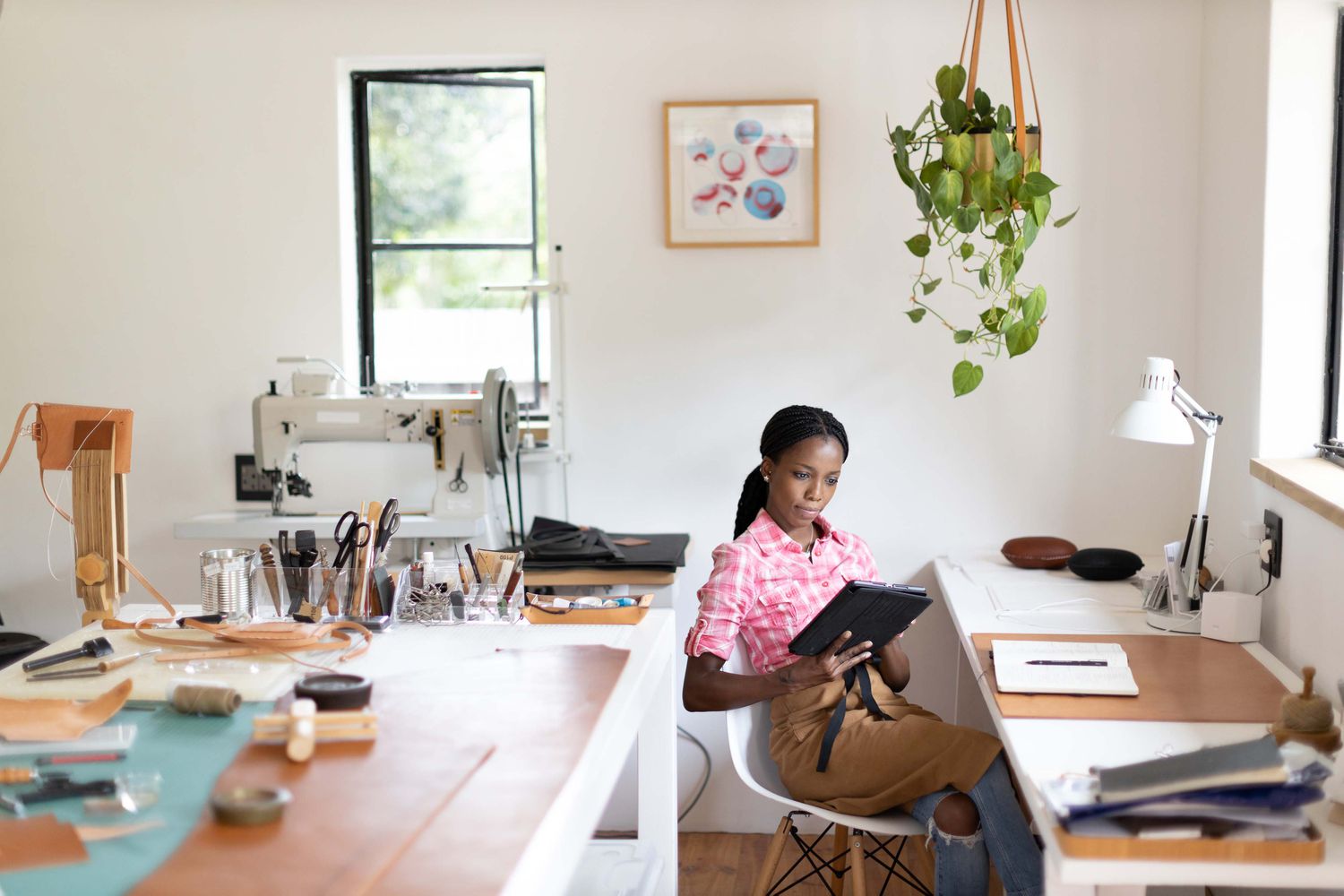 Female small business owner working in her leatherwork studio