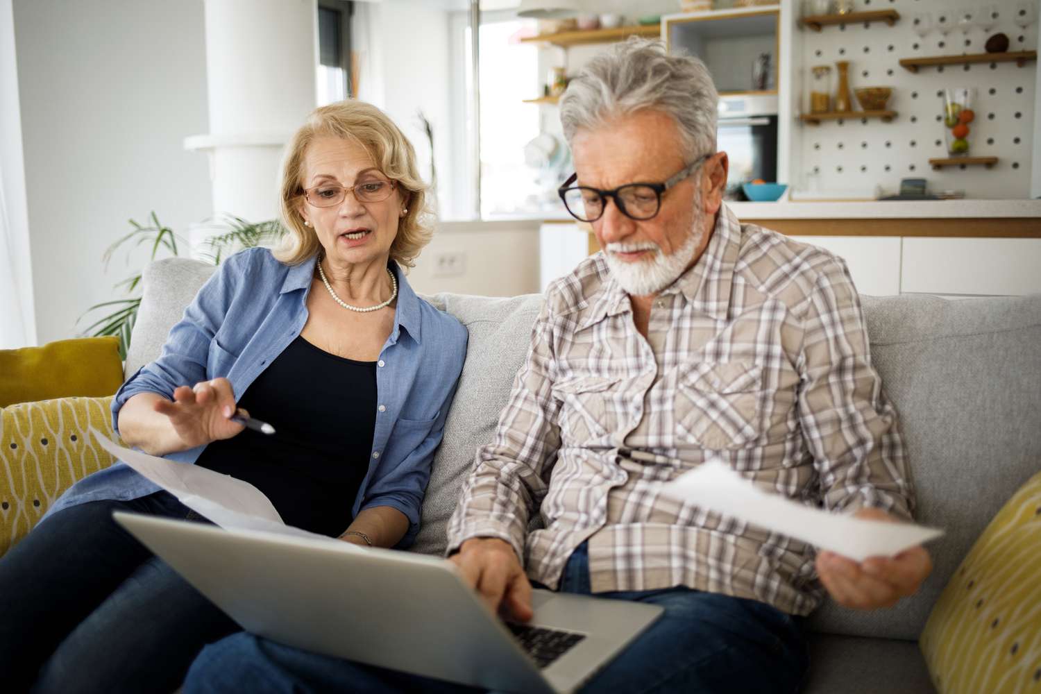 Senior couple looking at deed in lieu of foreclosure for their reverse mortgage.