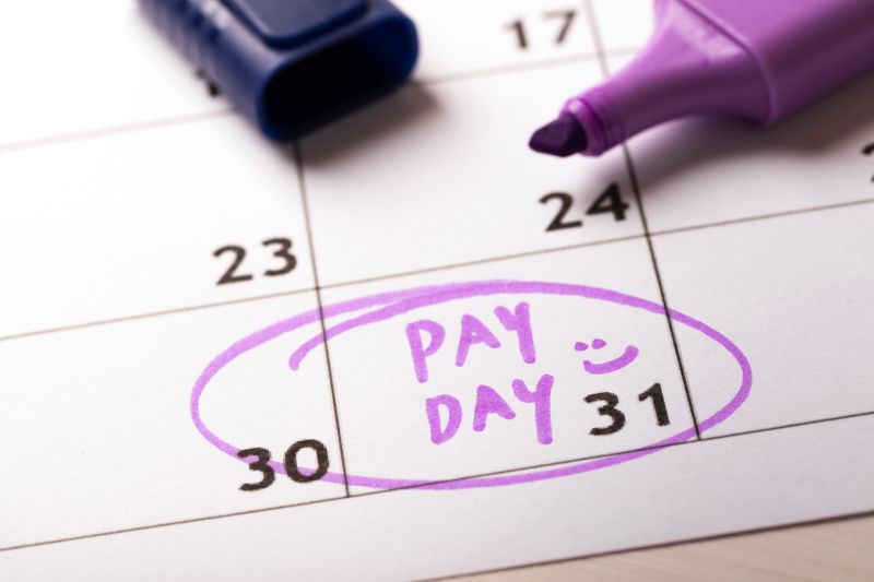 Payday concept calendar with marker and circled day of salary.