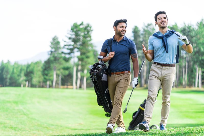 Two men playing golf on a sunny day