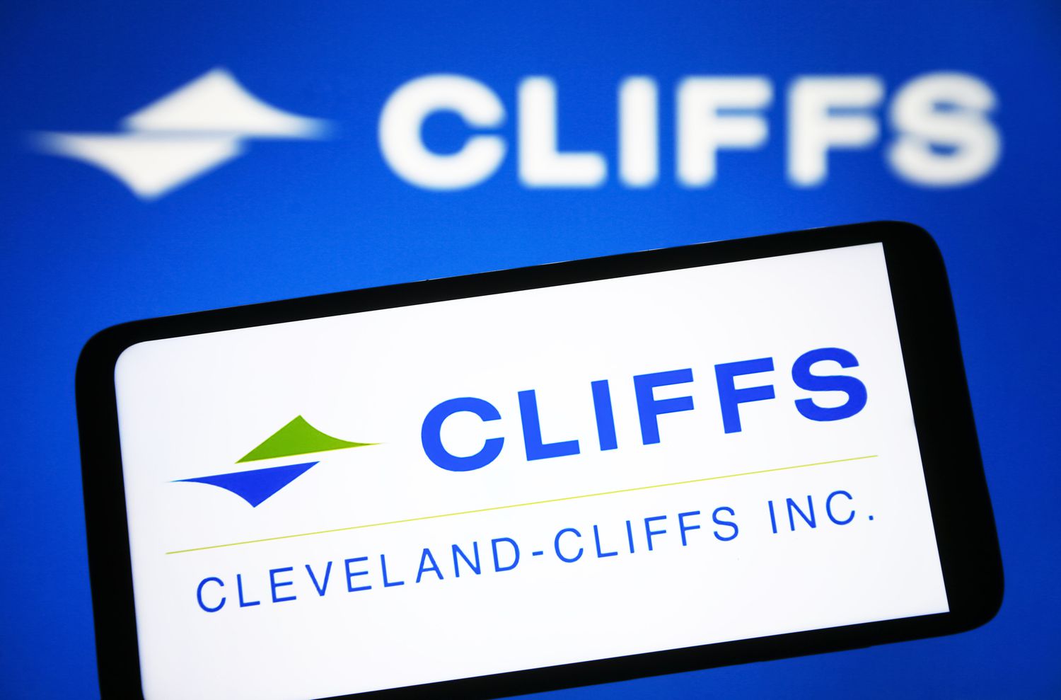 The Cleveland-Cliffs Inc. logo is seen on a smartphone and a PC screen