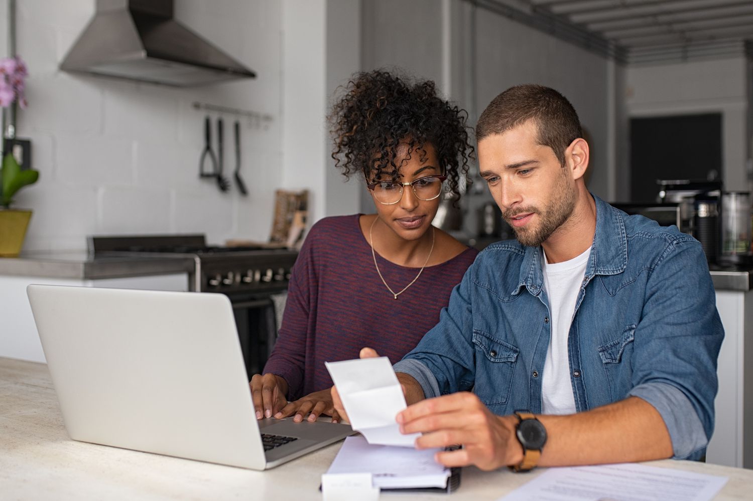 Couple looks over their finances as they consider a refi.