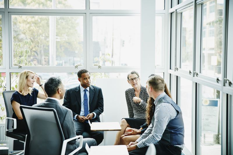 A group of business people sitting around a table