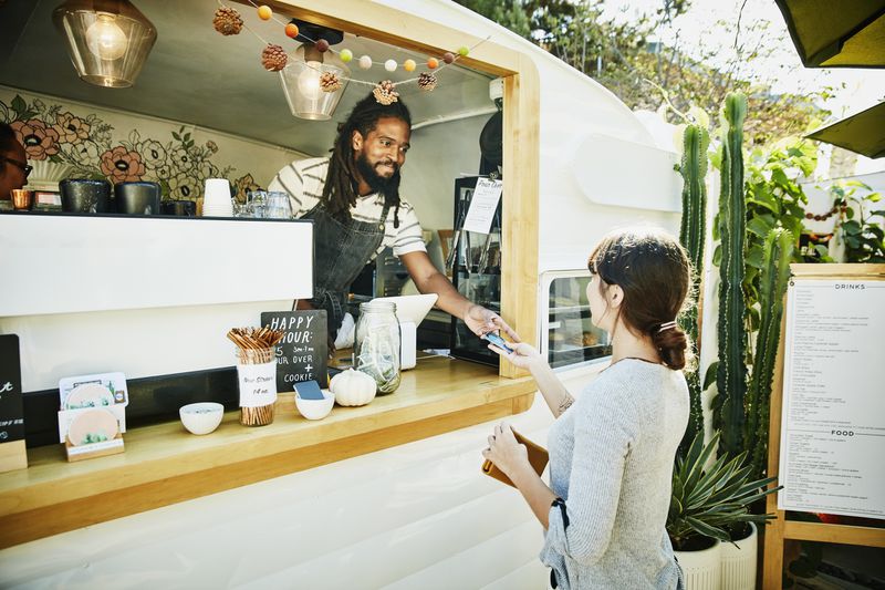 Food truck owner takes credit card payment from customer