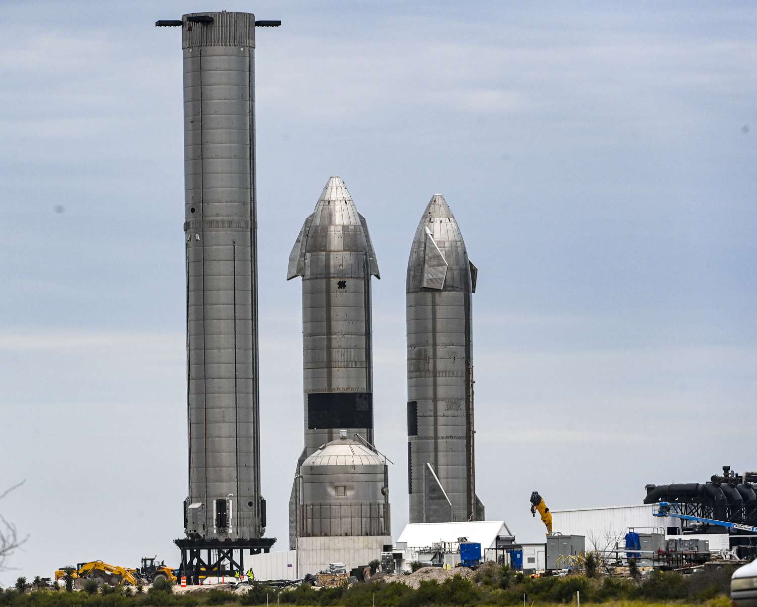 SpaceX Starship spacecraft prototypes and a super heavy booster sits at the companys Launch facility in south Texas