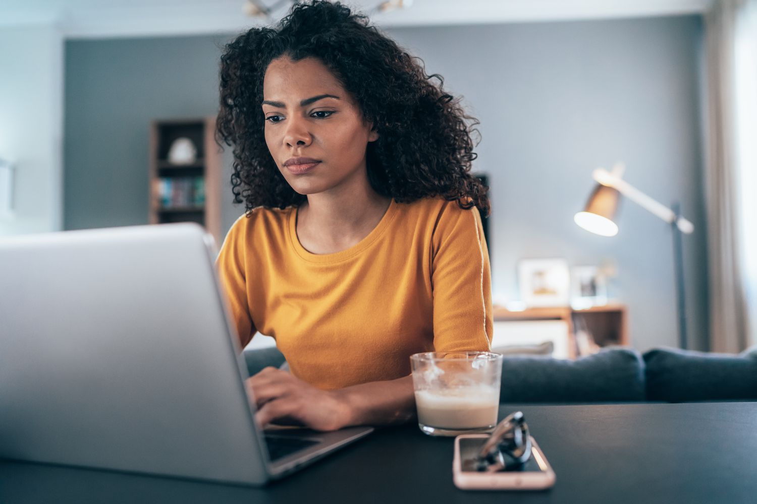 Woman reading tips for managing her student loan debt