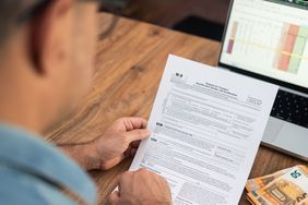 A man working on a W-9 Tax form