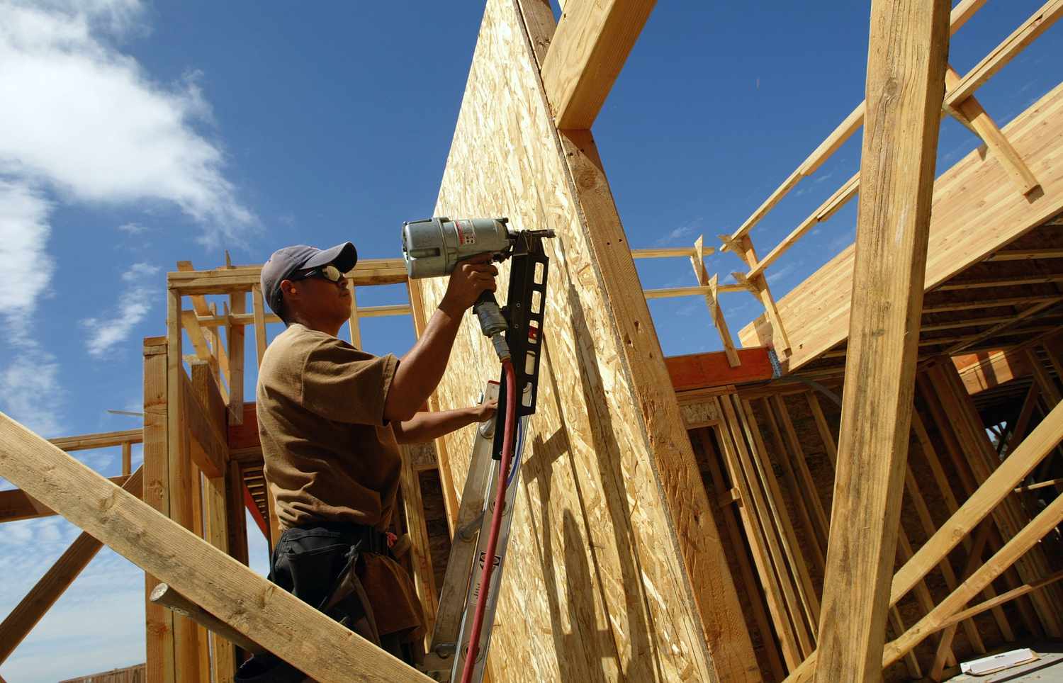 A man works on a home under construction. 