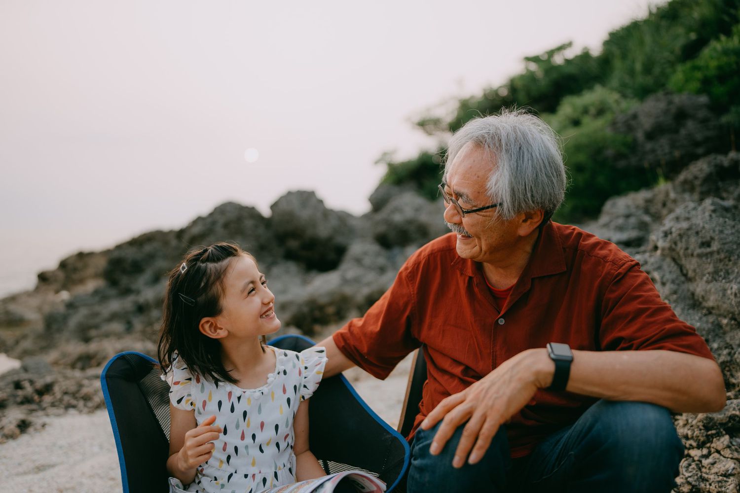 Grandfather and granddaughter at a beach