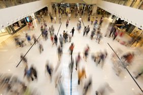 A photo illustration of blurred shoppers in a mall. 