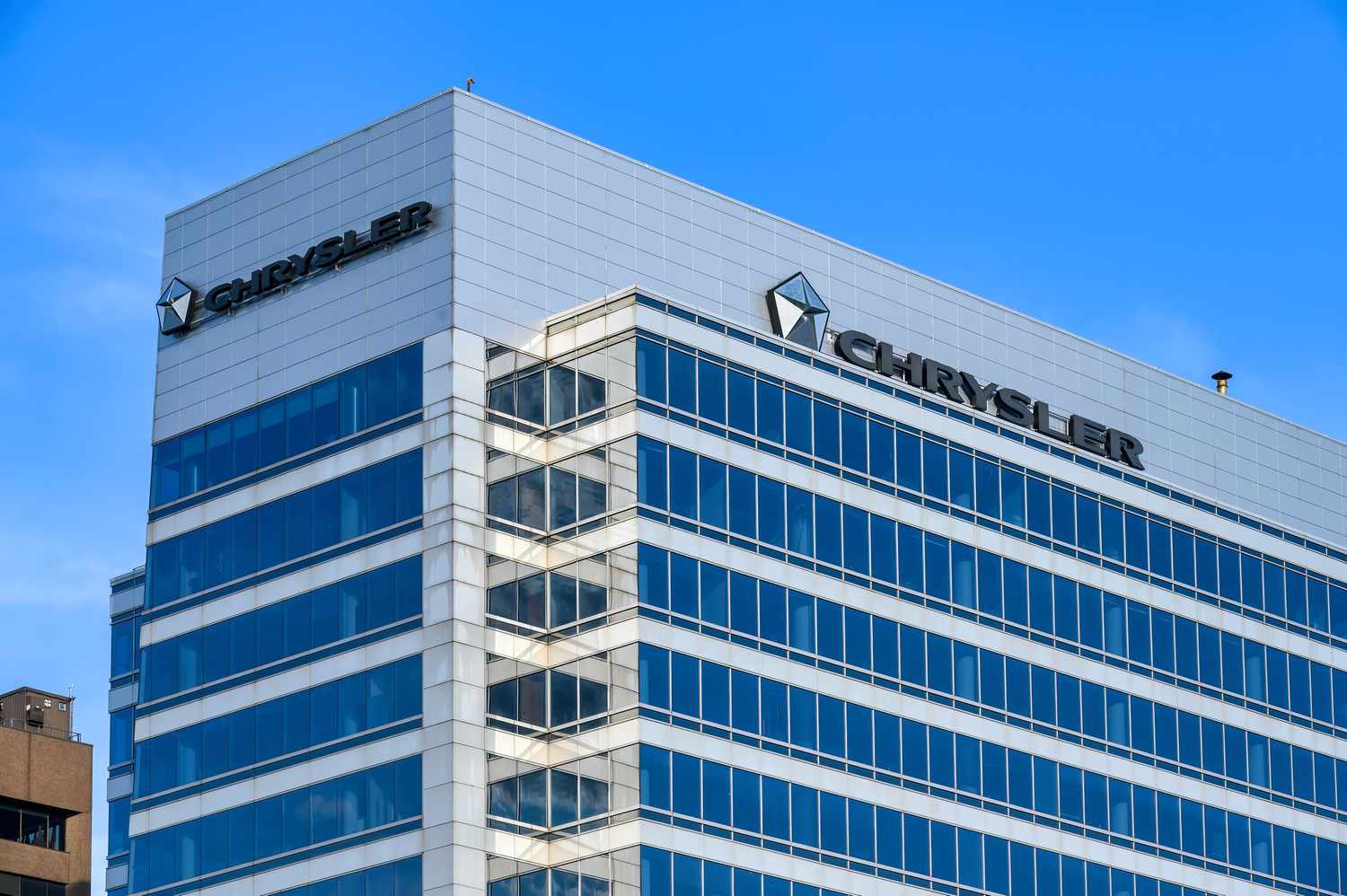 Business sign and logo of Chrysler on top of a modern building