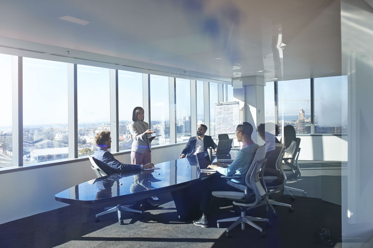 Young entrepreneur presenting project in exclusive boardroom.
