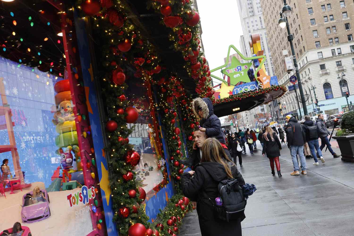 People look at the holiday window displays at a Macy's store in Herald Square on December 11, 2023 in New York City. Macy's stock rose more than 17% during morning trading after reports from the Wall Street Journal that Arkhouse Management, a real-estate focused investing firm, and Brigade Capital Management, a global asset manager, have offered to buy the retail chain for $5.8 billion.