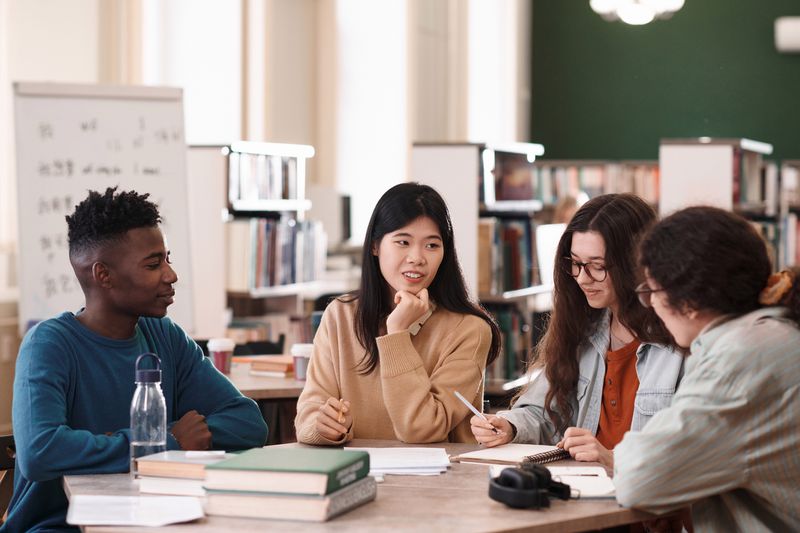 Group of students discussing the disadvantages of federal direct loans