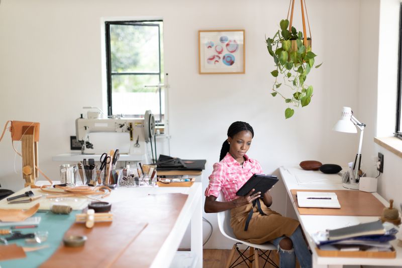 A small business owner looking at her tablet. 