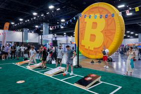 Attendees play cornhole at the expo hall during the Bitcoin 2023 conference in Miami Beach, Florida, US, on Saturday, May 20, 2023.