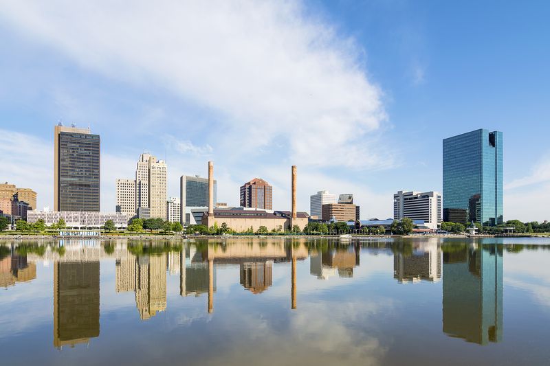 A panoramic view of downtown Toledo Ohio's skyline reflecting into the Maumee river. 