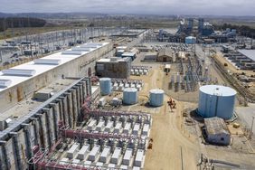 Power inverters, cabling and a substation outside the battery building at the Vistra Corp. Moss Landing Energy Storage Facility in Moss Landing, California