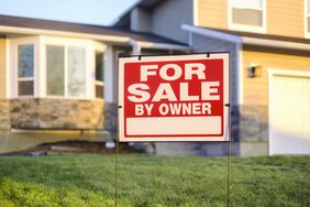 For Sale By Owner Sign and House